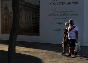 A couple walks through an empty Plaza San Martin in the historic center of Lima, Peru, 27 April 2020. Recovery of COVID-19 cases in Peru has slowed and there are currently more than 20,000 people with active disease in the country, where the number of deaths reached 782 people this Monday, according to official data. EFE/ Paolo Aguilar
