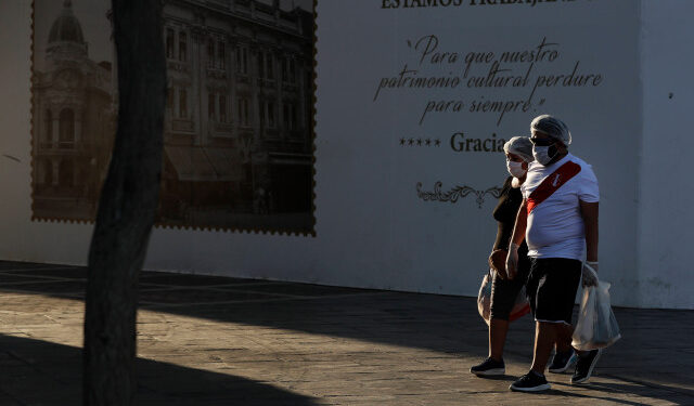 A couple walks through an empty Plaza San Martin in the historic center of Lima, Peru, 27 April 2020. Recovery of COVID-19 cases in Peru has slowed and there are currently more than 20,000 people with active disease in the country, where the number of deaths reached 782 people this Monday, according to official data. EFE/ Paolo Aguilar