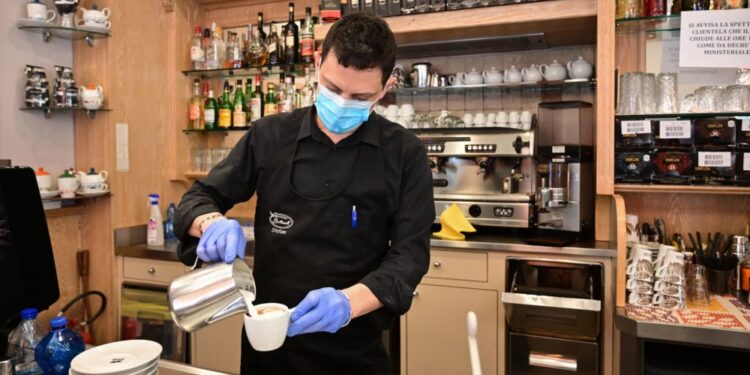 A waiter prepares a capuccino at a cafe in downtown Milan on March 10, 2020. - Italy imposed unprecedented national restrictions on its 60 million people on March 10, 2020 to control the deadly coronavirus, as China signalled major progress in its own battle against the global epidemic. (Photo by MIGUEL MEDINA / AFP) (Photo by MIGUEL MEDINA/AFP via Getty Images)