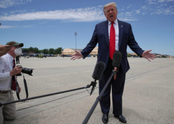 U.S. President Donald Trump shouts to be heard over the engine noise as he arrives to board Air Force One to travel to Florida to observe the launch of a SpaceX Falcon 9 rocket and Crew Dragon spacecraft, from Joint Base Andrews, Maryland, U.S. May 30, 2020. REUTERS/Jonathan Ernst