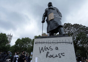The statue of former British prime minister Winston Churchill is seen defaced, with the words (Churchill) "was a racist" written on it's base in Parliament Square, central London after a demonstration outside the US Embassy, on June 7, 2020, organised to show solidarity with the Black Lives Matter movement in the wake of the killing of George Floyd, an unarmed black man who died after a police officer knelt on his neck in Minneapolis. - Taking a knee, banging drums and ignoring social distancing measures, outraged protesters from Sydney to London on Saturday kicked off a weekend of global rallies against racism and police brutality. (Photo by ISABEL INFANTES / AFP)