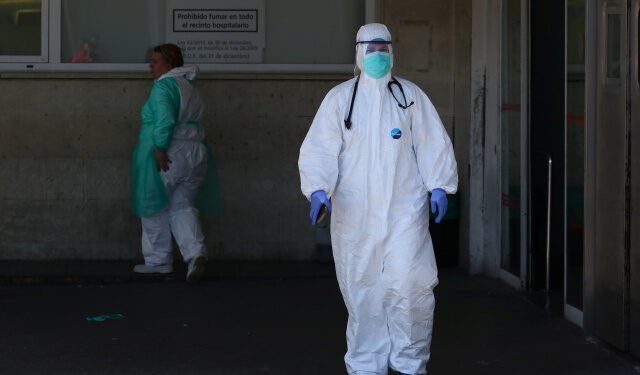 A healthcare worker is seen near the emergency unit at 12 de Octubre hospital during the coronavirus disease (COVID-19) outbreak in Madrid, Spain March 28, 2020. REUTERS/Sergio Perez