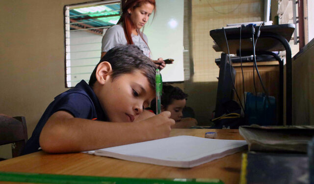 A boy does his homework after the closing of schools during the nationwide quarantine due to coronavirus disease (COVID-19) outbreak in San Cristobal, Venezuela March 20, 2020. Pictures tajen March 20, 2020 REUTERS/Carlos Eduardo Ramirez
