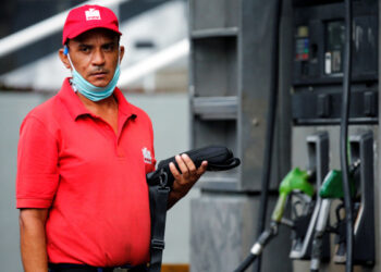 A worker of a gas station looks on, after Venezuela's government launched new fuel pricing system, in Caracas, Venezuela June 1, 2020. REUTERS/Manaure Quintero