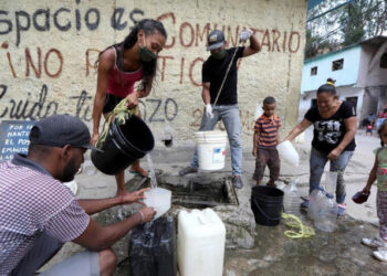 Personas extraen agua de una fuente desconocida en el vecindario de bajos ingresos de Petare, en medio del brote de la enfermedad por coronavirus (COVID-19) en Caracas, Venezuela. 3 de junio de 2020. REUTERS/Manaure Quintero