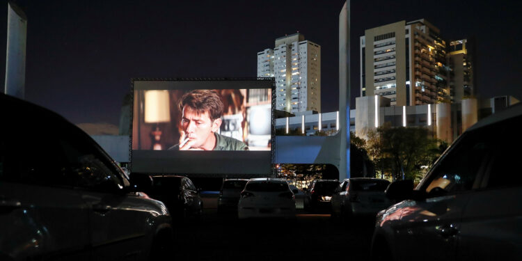 People on board their vehicles watch a movie in a drive-in theater, in Sao Paulo, Brazil, 17 June 2020. In a space enabled for about 100 vehicles at the Latin American Memorial, the inhabitants of Sao Paulo will be able to enjoy the seventh art while the cinemas in closed theaters recover their normality due to the ongoing coronavirus pandemic. EFE/ Sebastiao Moreira