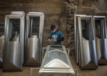 A worker makes a coffin at a factory at Juan de Lurigancho district in Lima, on June 3, 2020 amid the COVID-19 coronavirus pandemic. - While the Peruvian economy has been semi-paralyzed for 80 days due to the pandemic, coffin maker Genaro Cabrera has quadrupled his sales. (Photo by Ernesto BENAVIDES / AFP)