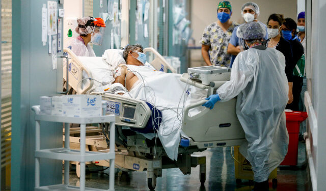 Nurses from the Critical Patients Unit transfer a patient infected with COVID-19 at El Carmen Hospital, in Santiago, May 6, 2020. (Photo by JAVIER TORRES / AFP)