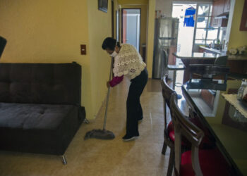 Mexican housekeeper Maria del Carmen Hernandez, 59, cleans at her home in Mexico City, on June 24, 2020. - In March, when the new coronavirus outbroke in latin America, many domestic workers were sent home without payment, others were laid off and others confined in the homes where they work. (Photo by CLAUDIO CRUZ / AFP)