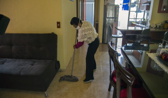 Mexican housekeeper Maria del Carmen Hernandez, 59, cleans at her home in Mexico City, on June 24, 2020. - In March, when the new coronavirus outbroke in latin America, many domestic workers were sent home without payment, others were laid off and others confined in the homes where they work. (Photo by CLAUDIO CRUZ / AFP)