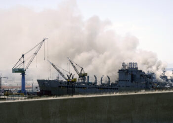 Smoke rises from a fire on board the U.S. Navy amphibious assault ship USS Bonhomme Richard at Naval Base San Diego, California, U.S. July 12, 2020. Photo taken from the San-Diego Coronado Bridge. REUTERS/Bing Guan