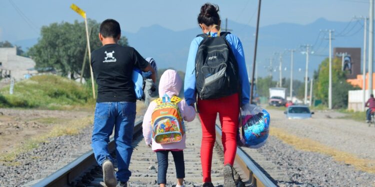 On 10 December 2014 outside of La Casa del Migrante, a catholic shelter that supports migrants near the Lechería Train Station, in the municipality of Tultitlan, State of Mexico, Maria [NAME CHANGED], 16 (on right), from Honduras travels north with her younger siblings, expecting to cross the border to the United States to reunite with her family.  Mexico, 7 July 2014 – Mexico and Central America countries are facing a very serious situation due to the increasing numbers of unaccompanied migrant children from Mexico and Central America countries arriving in the USA. According to the US government data, over 47,000 unaccompanied children have been apprehended at the southwest border in the past eight months, almost double the number apprehended between October 2012 and September 2013.