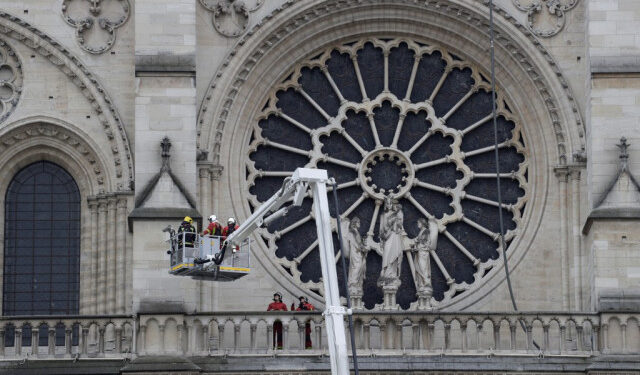 Firefighters secure Notre-Dame Cathedral in Paris on April 16, 2019, in the aftermath of a fire that caused its spire to crash to the ground. - Crowds of stunned Parisians and tourists -- some crying, others offering prayers -- watched in horror in central Paris on April 15 night as firefighters struggled for hours to extinguish the flames engulfing the Notre-Dame Cathedral. (Photo by Thomas SAMSON / AFP)
