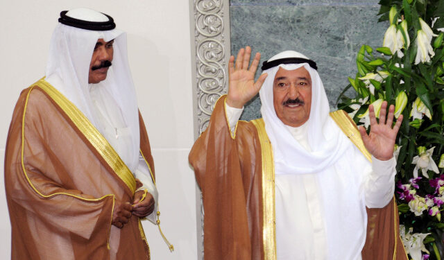 FILE PHOTO: Kuwait's Emir Sheikh Sabah al-Ahmad al-Sabah waves at the start of the forth session of the 13th legislative term of the parliament as Crown Prince Sheikh Nawaf al-Ahmad al-Sabah stands to his side in Kuwait City October 25, 2011. REUTERS/Stephanie McGehee/File Photo