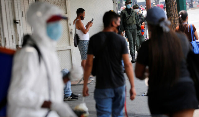 Members of the Bolivarian national guard wearing protective masks walk near a closed market during a nationwide quarantine as the spread of the coronavirus disease (COVID-19) continues, in Caracas, Venezuela April 20, 2020. REUTERS/Manaure Quintero