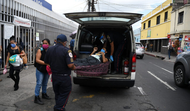 Municipal firefighters transfer a patient with symptoms related to the novel coronavirus at the COVID-19 unit of San Juan de Dios hospital in Guatemala City on July 13, 2020. - Doctors, deputies and the Human Rights Procurators Office (PDH) have raised the alarm about the imminent collapse of Guatemala's health system due to the increase of COVID-19 cases. (Photo by Johan ORDONEZ / AFP)