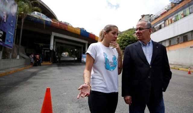 Juan Guillermo and Rafaela Requesens, father and sister of the lawmaker of the Venezuelan coalition of opposition parties (MUD) Juan Requesens, talk at the entrance of a detention centre of the Bolivarian National Intelligence Service (SEBIN) during a protest in support of him, in Caracas, Venezuela August 8, 2018. REUTERS/Adriana Loureiro