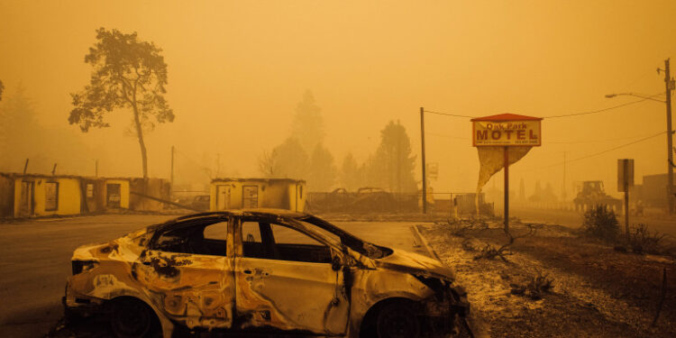 A charred vehicle is seen in the parking lot of the burned Oak Park Motel after the passage of the Santiam Fire in Gates, Oregon, on September 10, 2020. - California firefighters battled the state's largest ever inferno on September 10, as tens of thousands of people fled blazes up and down the US West Coast and officials warned the death toll could shoot up in coming days. At least eight people have been confirmed dead in the past 24 hours across California, Oregon and Washington, but officials say some areas are still impossible to reach, meaning the number is likely to rise. (Photo by Kathryn ELSESSER / AFP)
