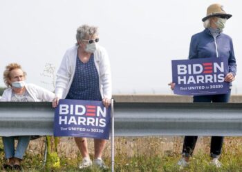 Vicki Smith, middle, and Karen DeMerit, right, wait for Democratic presidential candidate Joe Biden's arrival on Monday, Sept. 21, 2020, at Green Bay Austin Straubel International Airport in Ashwaubenon, Wis. "We are really excited to have president elect Joe Biden coming to Wisconsin," DeMerit said. "We are here to bring America back to civility and we feel that Biden is the person to bring the country that is so divided, together."  Ebony Cox/USA TODAY NETWORK-WisconsinGpgbiden11664