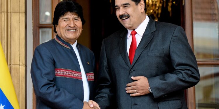 Venezuelan President Nicolas Maduro (R) shakes hands with his Bolivian counterpart Evo Morales during the Bolivarian Alliance for the Peoples of Our America (ALBA) Summit at the Miraflores presidential palace in Caracas on March 5, 2018. (Photo by Federico PARRA / AFP)