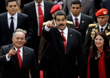 National Assembly President Diosdado Cabello, left, Venezuela's President-elect Nicolas Maduro, center, and his companion Cilia Flores greet supporters upon their  arrival to the Venezuelan Parliament for his inauguration in Caracas, Venezuela, Friday, April 19, 2013. The opposition boycotted the swearing-in, hoping that the ruling party's last-minute decision to allow an audit of nearly half the vote could change the result in a the bitterly disputed presidential election. (AP Photo/Fernando Llano)