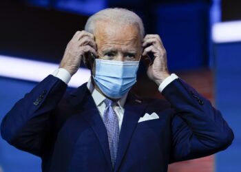 President-elect Joe Biden puts on his face mask after introducing nominees and appointees to key national security and foreign policy posts at The Queen theater, Tuesday, Nov. 24, 2020, in Wilmington, Del. (AP Photo/Carolyn Kaster)