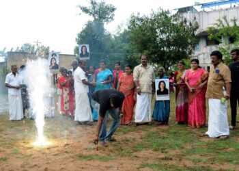 A man lights fireworks as villagers gather to celebrate the victory of U.S. Vice President-elect Kamala Harris in Painganadu near the village of Thulasendrapuram, where Harris' maternal grandfather was born and grew up, in the southern state of Tamil Nadu, India, November 8, 2020. REUTERS/Stringer NO ARCHIVES. NO RESALES.