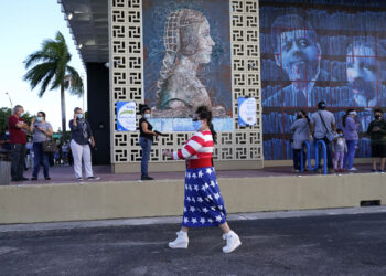 Yanitza Martinez wears red, white, and blue as she arrives to vote outside of the John F. Kennedy Library during the general election, Tuesday, Nov. 3, 2020, in Hialeah, Fla. (AP Photo/Lynne Sladky)