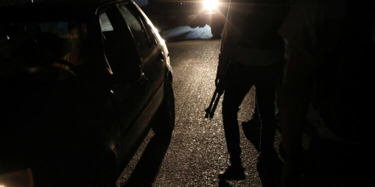 Members of the Special Action Force of the Venezuelan National Police (FAES) stand between passing cars during a night patrol, in Barquisimeto, Venezuela September 20, 2019. Picture taken September 20, 2019 REUTERS/Ivan Alvarado