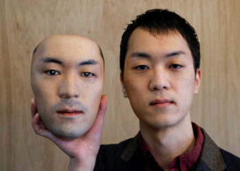 Shuhei Okawara, 30, owner of mask shop Kamenya Omote, holds a super-realistic face mask based on his real face, made by using 3D printing technology, in Tokyo, Japan December 16, 2020. REUTERS/Issei Kato