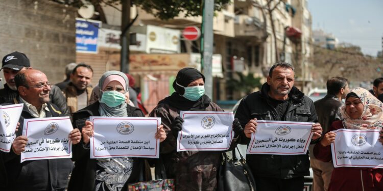 GAZA CITY, GAZA - MARCH 19: Palestinians gather for a demonstration to demand coronavirus (COVID-19) protection for Palestinian prisoners held in Israeli jails, in Gaza City, Gaza on March 19, 2020. (Photo by Ali Jadallah/Anadolu Agency via Getty Images)