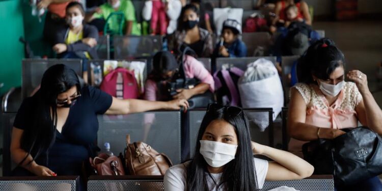Viajeros son vistos hoy en la Terminal de Ómnibus de Asunción. EFE/Nathalia Aguilar
