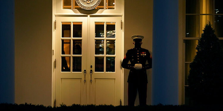 A Marine guard stands at the entrance to the West Wing of the White House, after the U.S. House impeached President Donald Trump in Washington, Wednesday, Jan. 13, 2021. The guard's presence signifies the president is in the Oval Office. (AP Photo/Gerald Herbert )