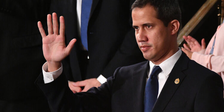 Venezuelan opposition leader Juan Guaido (C) waves as he is acknowledged by US President Donald Trump during his the State of the Union address at the US Capitol in Washington, DC, on February 4, 2020. (Photo by MANDEL NGAN / AFP)