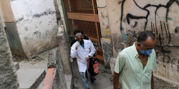A doctor takes part in a walking round at the low-income neighborhood of Las Mayas, as cases rise amid the coronavirus disease (COVID-19) outbreak, in Caracas, Venezuela July 14, 2020. Picture taken July 14, 2020. REUTERS/Manaure Quintero