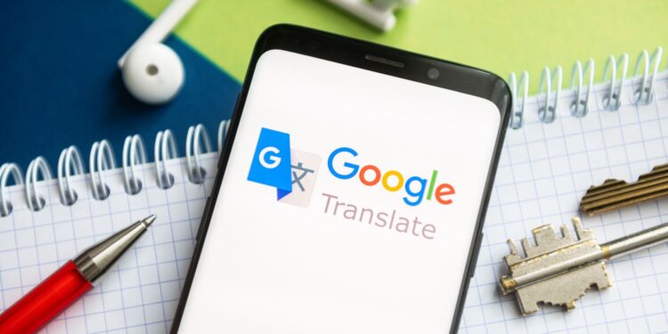 POLAND - 2021/02/09: In this photo illustration, a Google Translate logo seen displayed on a smartphone with a pen, key, book and headsets in the background. (Photo Illustration by Mateusz Slodkowski/SOPA Images/LightRocket via Getty Images)