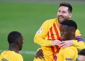 Barcelona's Spanish midfielder Ilaix Moriba (R) celebrates with Barcelona's Argentinian forward Lionel Messi and Barcelona's French forward Ousmane Dembele after scoring during the Spanish League football match between CA Osasuna and FC Barcelona at El Sadar stadium in Pamplona on March 6, 2021. (Photo by ANDER GILLENEA / AFP)