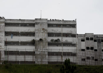 Prison guards stand on roof of the Ramo Verde military prison as opponents of President Nicolas Maduro hold a rally in front of the prison to ask for the release of jailed opposition leader Leopoldo Lopez in Los Teques, outskirts of Caracas, Venezuela, Friday, April 28, 2017. Venezuela's opposition called for a march to the prison where Lopez is serving a nearly 14-year sentence for his role leading anti-government demonstrations in 2014. (AP Photo/Ariana Cubillos)