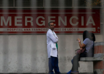 A doctor stands outside the Ana Francisca Perez de Leon hospital in Caracas on March 8, 2019 during the worst power outage in Venezuela's history. - Venezuela was plunged into darkness on Thursday after a massive electricity blackout paralyzed almost the entire country. (Photo by Cristian HERNANDEZ / AFP)        (Photo credit should read CRISTIAN HERNANDEZ/AFP/Getty Images)
