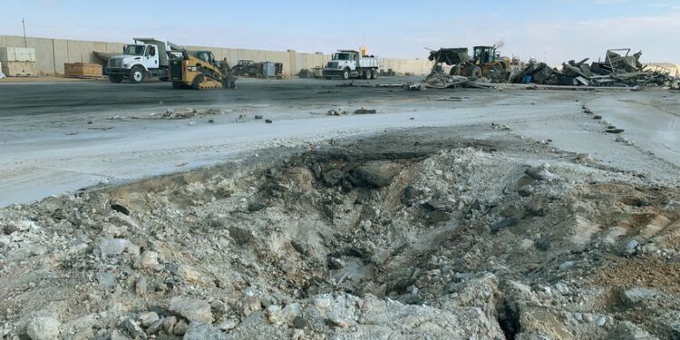 FILE - In this Jan. 13, 2020 file photo, Iranian bombing caused a crater at Ain al-Asad air base in Anbar, Iraq. Ain al-Asad air base was struck by a barrage of Iranian missiles, in retaliation for the U.S. drone strike that killed atop Iranian commander, Gen. Qassem Soleimani. The Pentagon now says 50 service members have been diagnosed with traumatic brain injury caused by the Jan. 8 Iranian missile attack on an air base in Iraq where U.S. and coalition troops had taken cover in advance. (AP Photo/Ali Abdul Hassan)