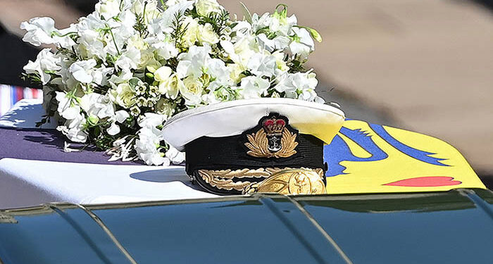 WINDSOR, ENGLAND - APRIL 17: Prince Philip, Duke of Edinburgh's Royal Navy cap sits on his coffin, which covered with His Royal Highness’s Personal Standard during the Ceremonial Procession during the funeral of Prince Philip, Duke of Edinburgh at Windsor Castle on April 17, 2021 in Windsor, England. Prince Philip of Greece and Denmark was born 10 June 1921, in Greece. He served in the British Royal Navy and fought in WWII. He married the then Princess Elizabeth on 20 November 1947 and was created Duke of Edinburgh, Earl of Merioneth, and Baron Greenwich by King VI. He served as Prince Consort to Queen Elizabeth II until his death on April 9 2021, months short of his 100th birthday. His funeral takes place today at Windsor Castle with only 30 guests invited due to Coronavirus pandemic restrictions. (Photo by Leon Neal/WPA Pool/Getty Images  )