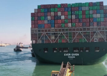 This picture taken on March 29, 2021 from a nearby tugboat in the Suez Canal shows a view of the Panama-flagged MV 'Ever Given' (operated by Taiwan-based Evergreen Marine) container ship as it begins to move. - Egypt's Suez Canal Authority said on March 29 the Ever Given container ship, which has been blocking the crucial waterway for nearly a week, has been "reorientated 80 percent in the right direction". Once it is refloated, it will take three and a half days to clear a traffic jam of hundreds of vessels, authorities said. Over 300 ships are currently waiting to travel through the canal. (Photo by - / AFP)
