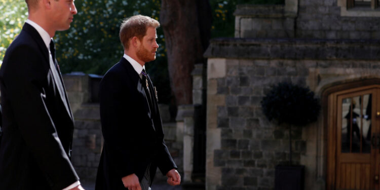Britain's Prince William and Britain's Prince Harry follow the hearse, a specially modified Land Rover, towards St. George's Chapel, during the funeral of Britain's Prince Philip, husband of Queen Elizabeth, who died at the age of 99, in Windsor, Britain, April 17, 2021. Alastair Grant/Pool via REUTERS     TPX IMAGES OF THE DAY