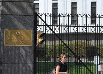 A pedestrian is seen in front of the Embassy of Russia in Washington, DC on April 15, 2021. - The US announced sanctions against Russia on April 15, 2021, and the expulsion of 10 diplomats in retaliation for what Washington says is the Kremlin's US election interference, a massive cyber attack and other hostile activity. President Joe Biden ordered a widening of restrictions on US banks trading in Russian government debt, expelled 10 diplomats who include alleged spies, and sanctioned 32 individuals alleged to have tried to meddle in the 2020 presidential election, the White House said. (Photo by MANDEL NGAN / AFP)