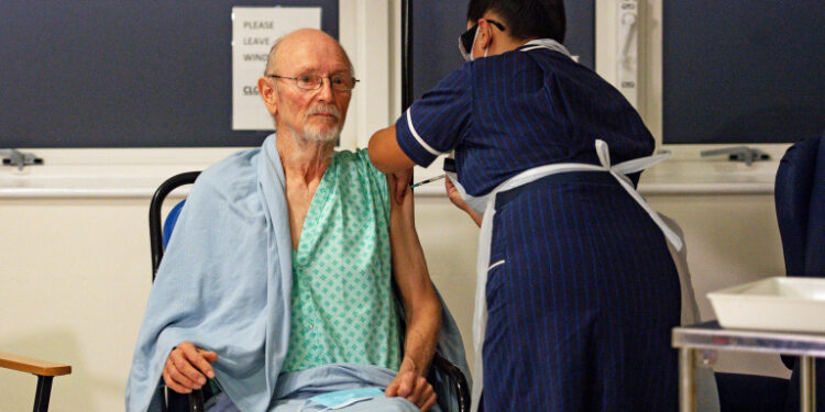 "Bill" William Shakespeare, 81, receives the Pfizer/BioNTech  COVID-19 vaccine at University Hospital, at the start of the largest ever immunisation programme in the British history, in Coventry, Britain December 8, 2020. Britain is the first country in the world to start vaccinating people with the Pfizer/BioNTech jab. Jacob King/Pool via REUTERS     TPX IMAGES OF THE DAY