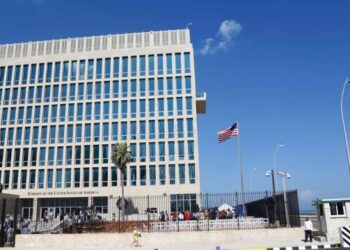 In this photo taken Aug. 14, 2015, a U.S. flag flies at the U.S. embassy in Havana, Cuba.   American diplomats who served in Cuba have been diagnosed with mild traumatic brain injury following mysterious, unexplained attacks on their health, the union that represents U.S. diplomats said Friday, in the most detailed account to date of the growing list of symptoms.  (AP Photo/Desmond Boylan)