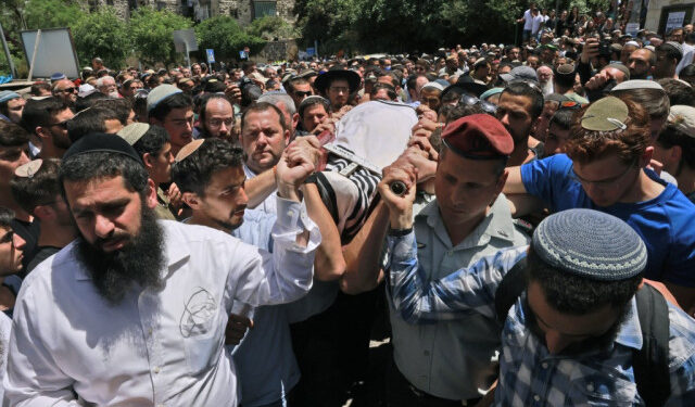 Israeli mourners attend the funeral of Yehuda Gueta, a 19-year-old Yeshiva student, in Jerusalem on May 6, 2021, after succumbed to his wounds following a Palestinian drive-by shooting attack earlier this week in the occupied West Bank. - Suspected Palestinian gunmen carried out a drive-by shooting at a nearby junction the previous, leaving three Israeli civilians wounded, one of them in critical condition. (Photo by Menahem KAHANA / AFP)