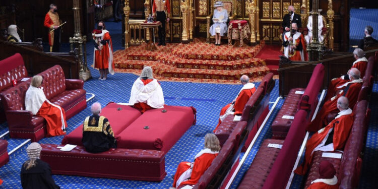 Britain's Queen Elizabeth II reads the Queen's Speech on the The Sovereign's Throne in the socially distanced House of Lords chamber, during the State Opening of Parliament at the Houses of Parliament in London on May 11, 2021, which is taking place with a reduced capacity due to Covid-19 restrictions. - The State Opening of Parliament is where Queen Elizabeth II performs her ceremonial duty of informing parliament about the government's agenda for the coming year in a Queen's Speech. (Photo by Eddie MULHOLLAND / POOL / AFP)