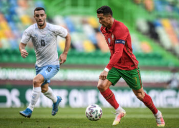 Portugal's forward Cristiano Ronaldo controls the ball next to Israel's midfielder Neta Lavi (L) during the international friendly football match between Portugal and Israel at the Jose Alvalade stadium in Lisbon in preparation for the UEFA EURO 2020 football competition, on June 9, 2021. (Photo by PATRICIA DE MELO MOREIRA / AFP)