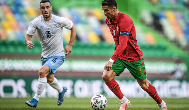 Portugal's forward Cristiano Ronaldo controls the ball next to Israel's midfielder Neta Lavi (L) during the international friendly football match between Portugal and Israel at the Jose Alvalade stadium in Lisbon in preparation for the UEFA EURO 2020 football competition, on June 9, 2021. (Photo by PATRICIA DE MELO MOREIRA / AFP)